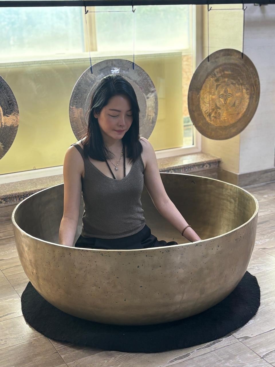 Camilla in a large singing bowl meditation setting