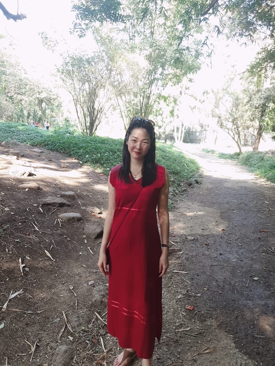 Camilla in a red dress during spiritual travel
