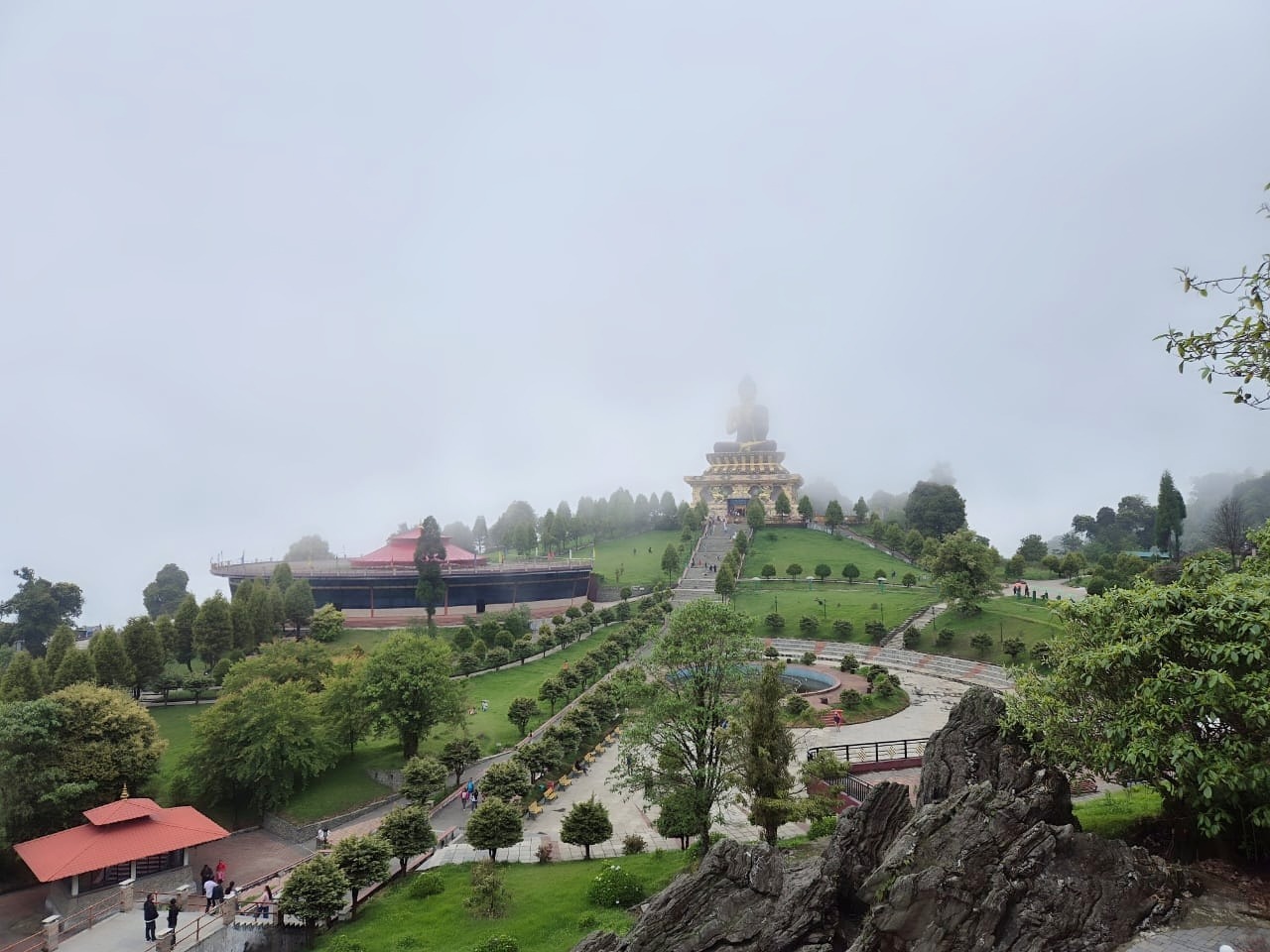 Large Buddha statue in a misty mountain setting