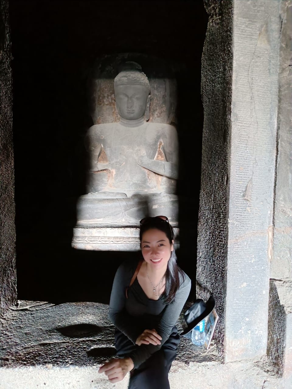 Camilla inside a cave temple with Buddha statue