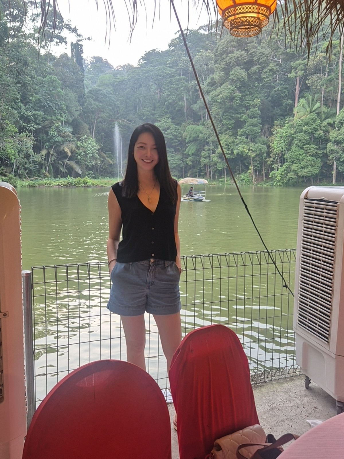 Camilla standing beside a lake and waterfall